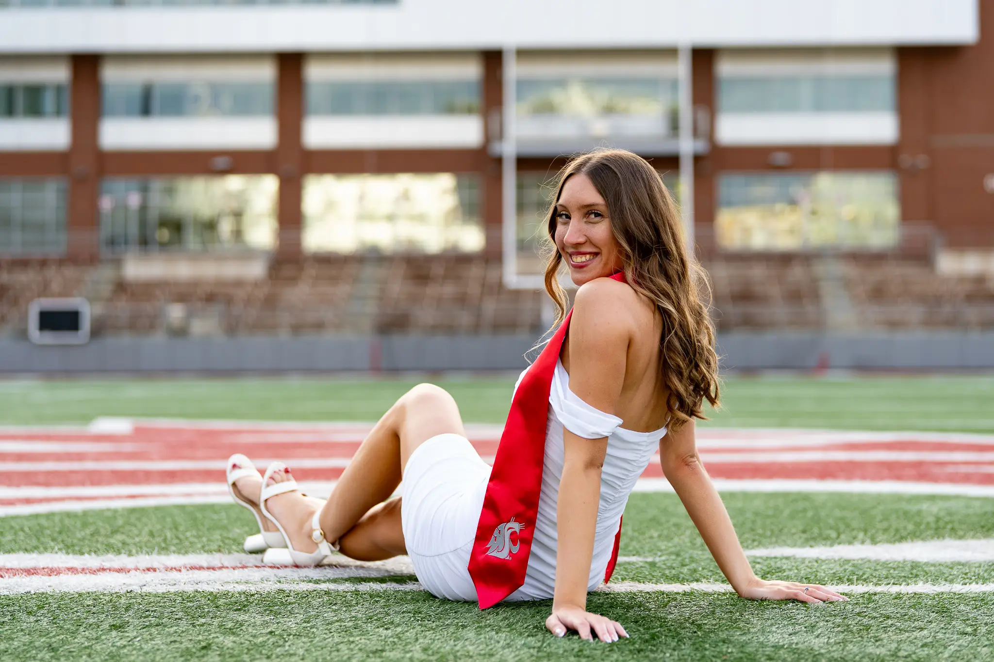 Graduate celebrating in cap and gown at Washington State University in Pullman, WA